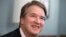FILE - Supreme Court nominee Judge Brett Kavanaugh smiles during a meeting with Sen. Mike Lee, R-Utah, on Capitol Hill in Washington, July 18, 2018.