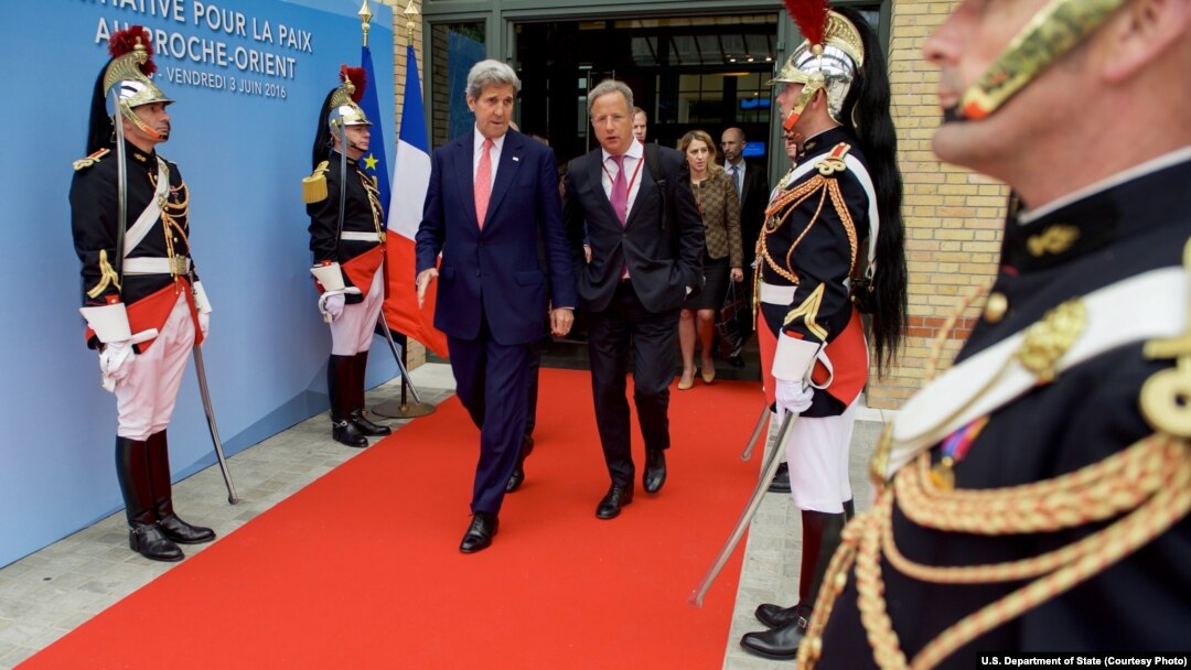 U.S. Secretary of State John Kerry, left, walks with Special Envoy for Israeli-Palestinian Negotiations Frank Lowenstein as they exit the MFA Convention Center in Paris, France, following a French-sponsored Middle East conference, June 3, 2016.