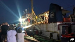 FILE - The Dutch-flagged Sea-Watch 3 ship docks at the Lampedusa harbor, Italy, early Saturday, June 29, 2019. Forty migrants have disembarked on a tiny Italian island after the captain of the German aid ship which rescued them docked without permission. 