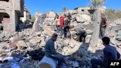 People search the rubble for missing persons at the site of an Israeli strike a day earlier that hit the Al-Loh family home in Beit Lahia, in the northern Gaza Strip on Oct. 30, 2024.