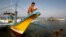 A Filipino fisherman sits on the hull of his boat after arriving from Scarborough Shoal in Masinloc, Zambales May 10, 2012.