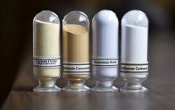 FILE - Samples of rare earths minerals from left, Cerium oxide, Bastnasite, Neodymium oxide and Lanthanum carbonate are on display during a tour of Molycorp's Mountain Pass Rare Earth facility in Mountain Pass, California, June 29, 2015.