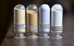 FILE - Samples of rare earth minerals from left, Cerium oxide, Bastnasite, Neodymium oxide and Lanthanum carbonate are on display during a tour of Molycorp's Mountain Pass Rare Earth facility in Mountain Pass, California, June 29, 2015.