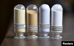 FILE - Samples of rare earth minerals from left, Cerium oxide, Bastnasite, Neodymium oxide and Lanthanum carbonate are on display during a tour of Molycorp's Mountain Pass Rare Earth facility in Mountain Pass, California, June 29, 2015.
