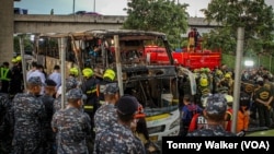 Authorities and firefighters respond after a bus carrying 44 people crashed and caught fire, in suburban Bangkok, Oct. 1, 2024.