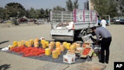 A local reporter films the explosives seized by National Directorate of Security in Kabul, Afghanistan, Oct. 15, 2017. Afghan police said they foiled a major bombing in the capital after arresting a suspect whose truck was loaded with explosives.