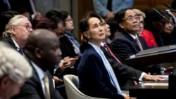 (FILES) In this file photo taken on December 11, 2019 Myanmar's State Counsellor Aung San Suu Kyi (C) stands before the UN's International Court of Justice next to Abubacarr Tambadou (2L), minister of justice of the Gambia, in the Peace Palace of…