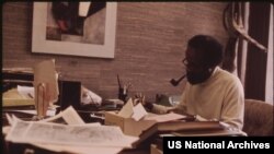 FILE - Lerone Bennett Jr. working in his office at the Johnson Publishing Company in Chicago in October 1973.