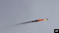 Syrian government helicopter is hit by a missile in Idlib province, Syria, Feb. 11, 2020.