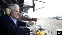 Defense Secretary Robert Gates watches flight operations aboard the USS Abraham Lincoln in the Arabian Sea', 6 Dec 2010