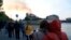 Para pengunjung menyaksikan dari kejauhan saat api dan asap membubung dari Katedral Notre Dame yang terbakar di Paris, Senin, 15 April 2019. 