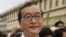 Cambodian opposition party leader Sam Rainsy, stands in front of the municipal court in Phnom Penh, Cambodia. 