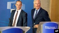 Britain's Secretary of State for Exiting the European Union Dominic Raab, left, and EU chief Brexit negotiator Michel Barnier arrive for a press conference at EU headquarters in Brussels, Aug. 21, 2018.