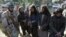 Taliban militants, right, who were arrested by Afghan border police, stand during a presentation of seized weapons and equipment, Jalalabad, Dec. 29, 2015.