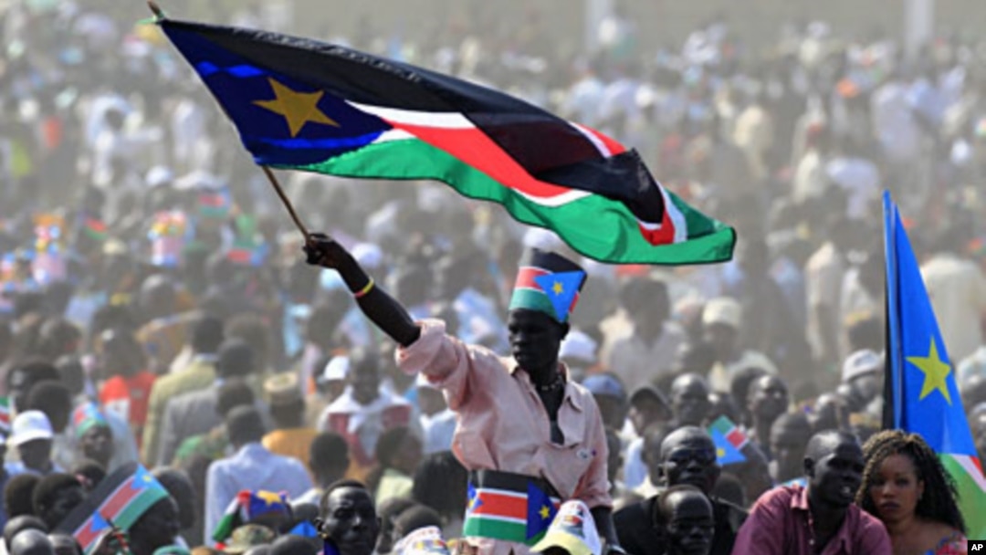 A man waves South Sudan's national flag as he attends the Independence Day celebrations in the capital Juba, July 9, 2011