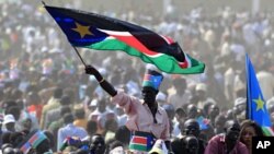 A man waves South Sudan's national flag as he attends the Independence Day celebrations in the capital Juba, July 9, 2011.