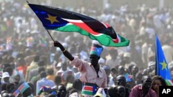 A man waves South Sudan's national flag as he attends the Independence Day celebrations in the capital Juba, July 9, 2011