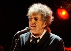FILE - Bob Dylan performs in Los Angeles, Jan. 12, 2012.