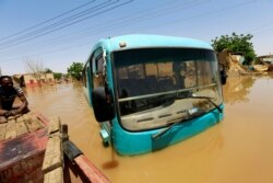 A bus is seen partially submerged in flood waters near the River Nile, on the outskirts of Khartoum, Sudan, Sept. 2, 2019.