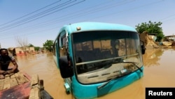 FILE: A bus is seen partially submerged in flood waters near the River Nile, on the outskirts of Khartoum, Sudan. Taken 9.2.2019