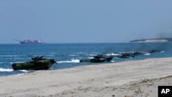Amphibious Assault Vehicles, AAVs, carrying American and Philippine troops, make a beach landing during the Joint US-Philippine Military Exercise dubbed "Balikatan 2019" Thursday, April 11, 2019, off San Antonio, Philippines.