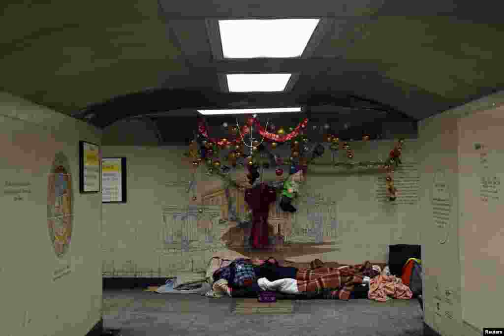 Homeless man Kel sleeps in the spot where he lives in the subway next to Hyde Park Station in London, Britain.