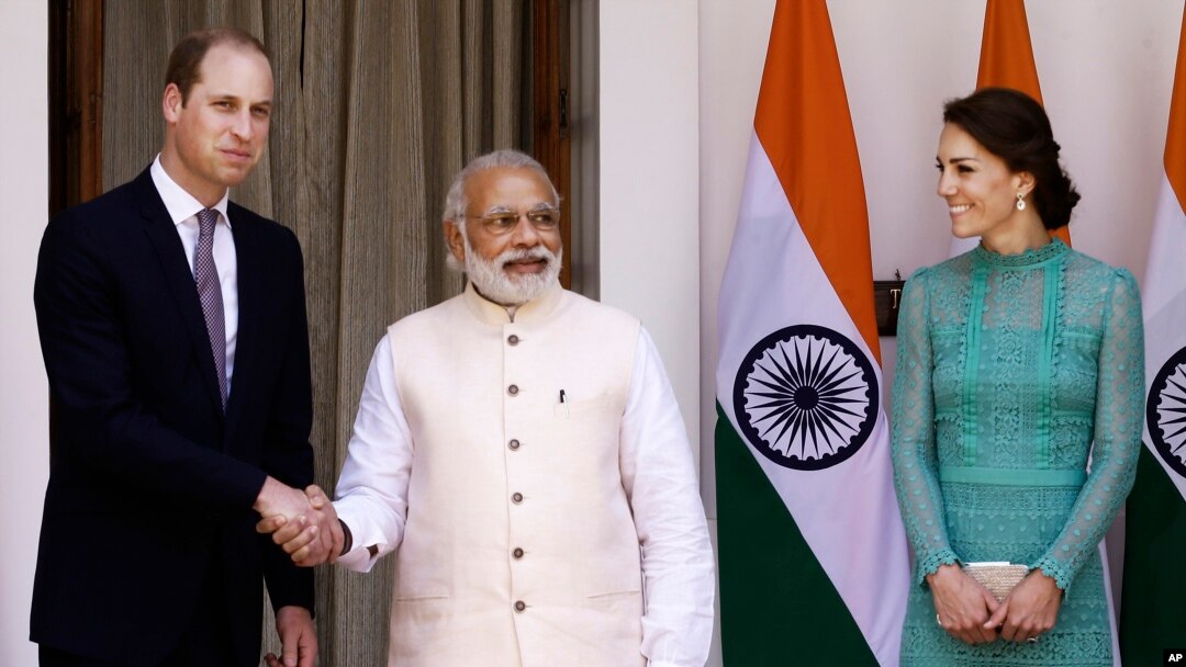 Britain's Prince William, left, and his wife Kate, the Duchess of Cambridge, right, are greeted by Indian Prime Minister Narendra Modi as they arrive for a lunch with him, in New Delhi, India, Tuesday, April 12, 2016.