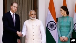 Britain's Prince William, left, and his wife Kate, the Duchess of Cambridge, right, are greeted by Indian Prime Minister Narendra Modi as they arrive for a lunch with him, in New Delhi, India, Tuesday, April 12, 2016.