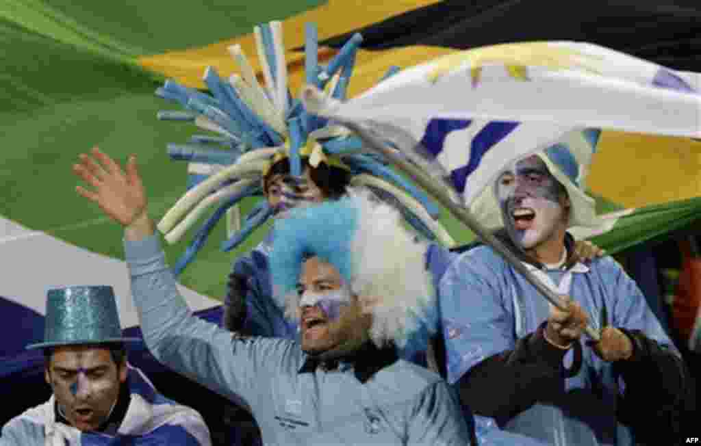 Uruguayan fans cheer as they wait for the start of the World Cup group A soccer match between South Africa and Uruguay at the Loftus Versfeld Stadium in Pretoria, South Africa, Wednesday, June 16, 2010. (AP Photo/Marcio Jose Sanchez)