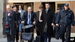 Harvey Weinstein, fourth from left, leaves the courthouse during jury deliberations in his rape trial, Feb. 21, 2020, in New York.