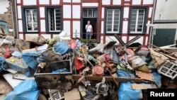 A man looks on outside a house in an area affected by floods caused by heavy rainfalls in Bad Muenstereifel, Germany.