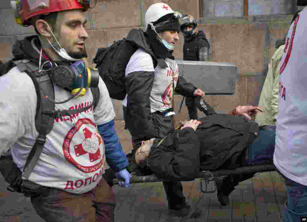 An anti-government protester wounded by firearms is carried to a makeshift clinic in central Kyiv, Ukraine, Feb. 20, 2014.&nbsp;