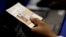 FILE - An election official checks a voter's photo identification at an early voting polling site in Austin, Texas, Feb. 26, 2014.