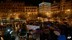 A woman holds a sign reading ''Only Yes is Yes'' as people gather at Plaza del Castillo square to a protest against sex assault, in Pamplona, northern Spain, Nov. 4, 2019.