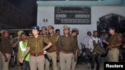 Local police stand outside a house where a suspected militant is said to be hiding in Thakurganj area in Lucknow, India, March 7, 2017. 