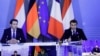 French President Emmanuel Macron, right, and Austria's Chancellor Sebastian Kurz, left, speak via videoconference shown on a screen in the European Council building in Brussels, Belgium, Nov. 10, 2020.