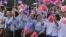 Cambodian students wave their national flags during a ceremony to celebrate its Independence Day, file photo. 