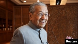 FILE - Malaysia's Prime Minister Mahathir Mohamaad reacts during an interview with Reuters in Putrajaya, Dec. 10, 2019.