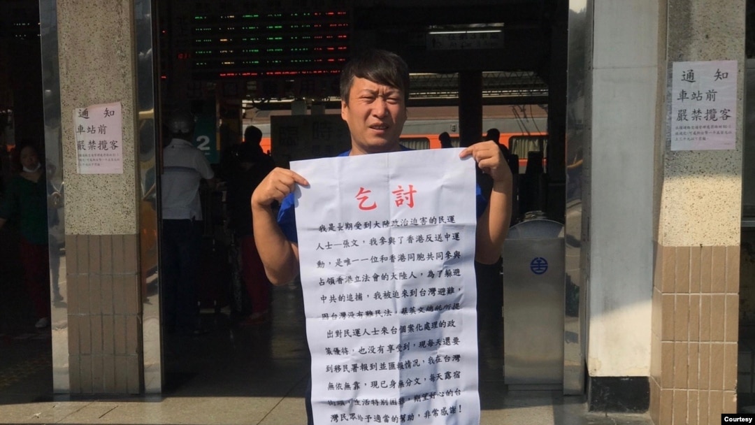 從中國大陸到台灣申請政治庇護的張文手持乞討說明。（溫起鋒提供） 