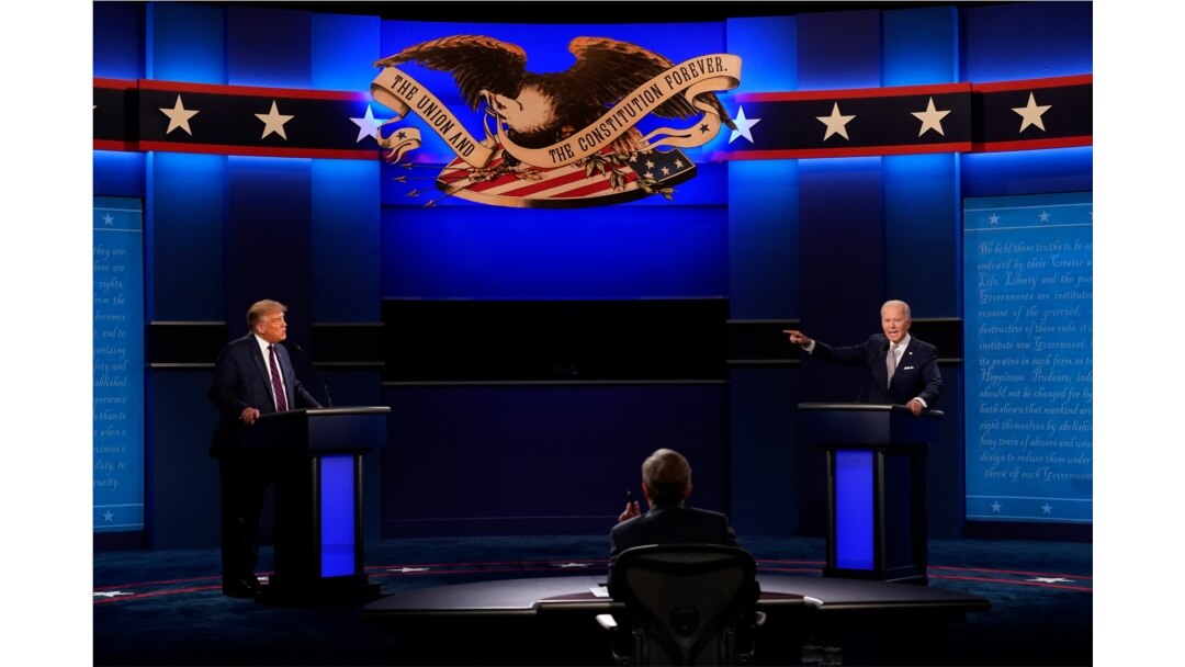 FILE - President Donald Trump, left, Democratic presidential candidate former Vice President Joe Biden, right, during the first presidential debate with moderator Chris Wallace of Fox News, center, Sept. 29, 2020, in Cleveland, Ohio.
