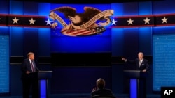 President Donald Trump, left, Democratic presidential candidate former Vice President Joe Biden, right, speaking during the first presidential debate with moderator Chris Wallace of Fox News, center, Sept. 29, 2020, at Case Western University.