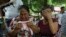 Mujeres lloran mientras explican que tres de sus familiares fueron asesinados el día anterior en El Ripial, estado de Apure, Venezuela, luego de cruzar el río hacia Arauquita, Colombia, el viernes 26 de marzo de 2021. Los venezolanos buscan refugio en Col