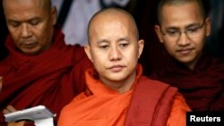 Buddhist monk Wirathu (C), leader of the 969 movement, greets other monks as he attends a meeting on the National Protection Law at a monastery outside Yangon, June 27, 2013. 