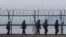 South Korean army soldiers patrol along a barbed-wire fence near the border village of the Panmunjom, in Paju, South Korea.