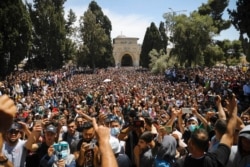 FILE - Worshippers protest against the likely evictions of Palestinians from their homes, after the last Friday prayers of the Muslim holy month of Ramadan at the Al-Aqsa mosque compound in the Old City of Jerusalem, May 7, 2021.