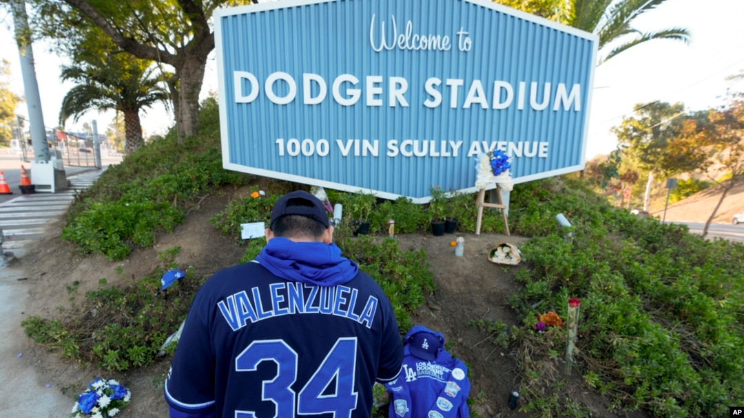 A person stands outside Dodger Stadium after the death of former Dodgers pitcher Fernando Valenzuela, in Los Angeles, Oct. 23, 2024.