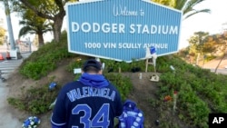 A person stands outside Dodger Stadium after the death of former Dodgers pitcher Fernando Valenzuela, in Los Angeles, Oct. 23, 2024.