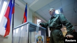 Seorang anggota militer Republik Rakyat Luhansk (LPR) ketika memberikan suara selama referendum untuk bergabung dengan LPR ke Rusia, di sebuah unit militer di Luhansk, Ukraina, 23 September 2022. (Foto: REUTERS/Alexander Ermochenko)