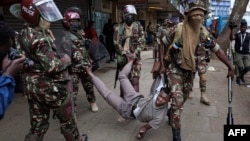 FILE - Anti-riot police officer arrest a suspected protester during a demonstration against the government in Nairobi, Kenya, Aug. 8, 2024.