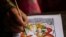 Tej Kumari Chitrakar makes a traditional painting ahead of Naag Panchami festival at her residence in Bhaktapur, Nepal, July 31, 2019.